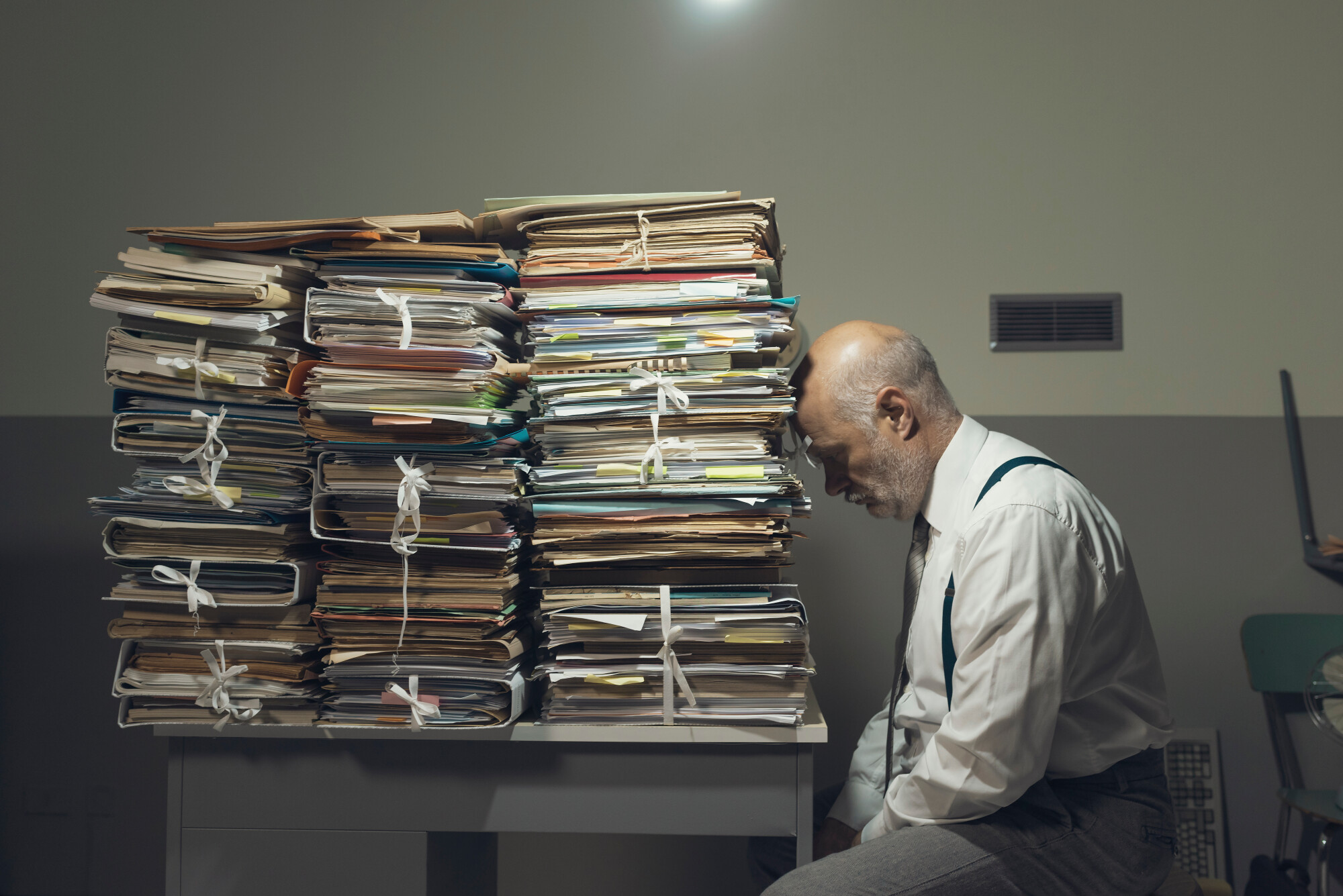 Depressed Man with Stacks of Folders