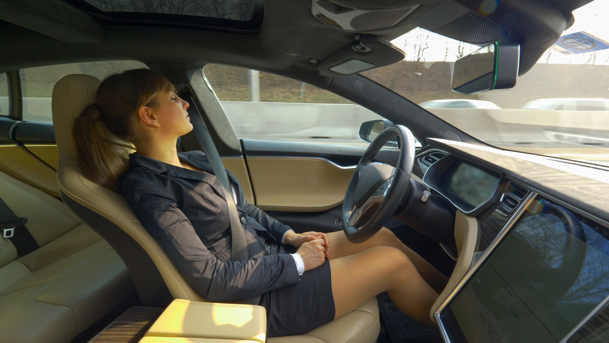 Women Asleep Behind Wheel of Autonomous Vehicle